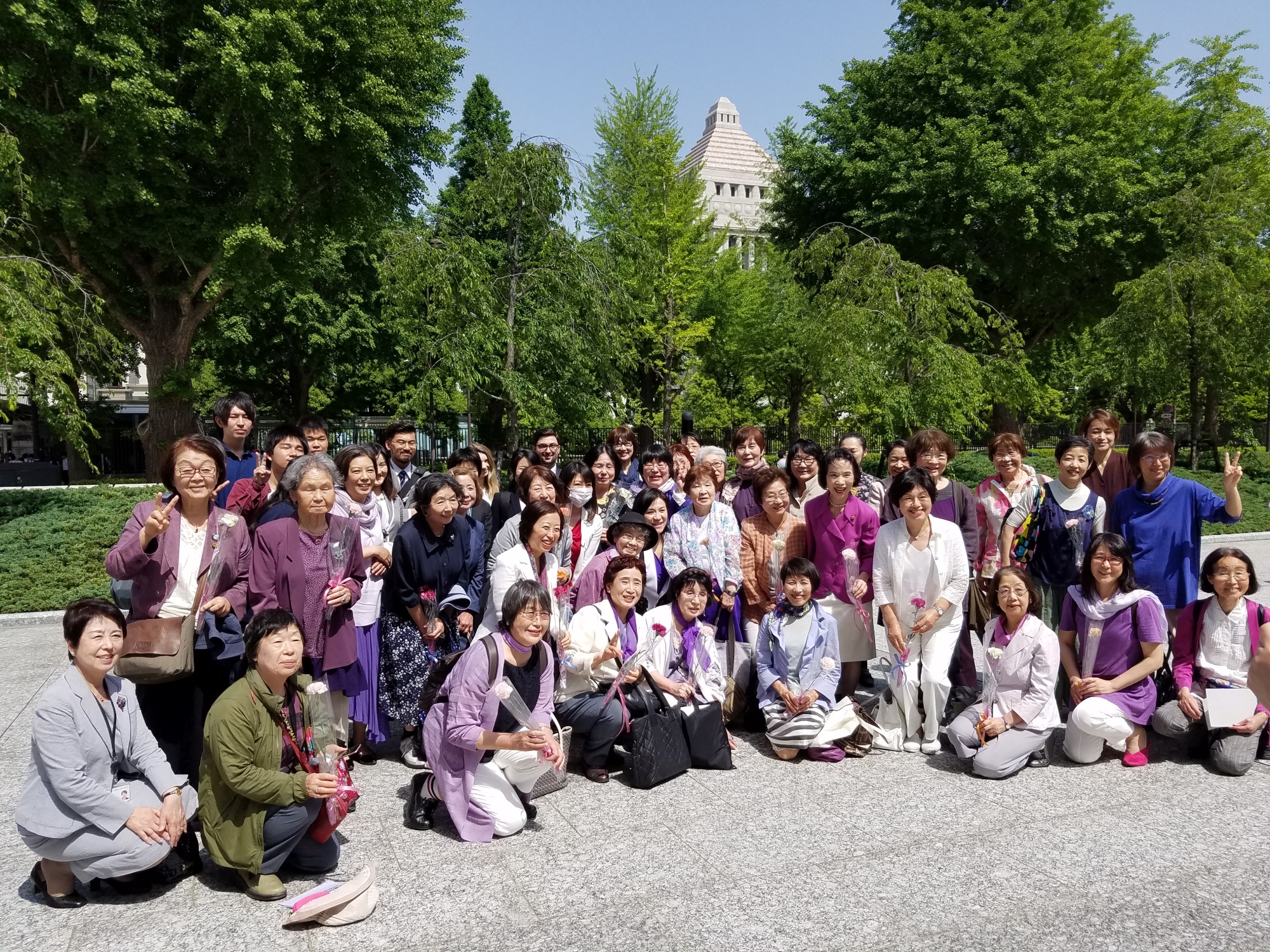 Supporters of a bill seeking to achieve 50-50 gender equality in the Diet and local assemblies pose for a photo in front of the Diet building on Wednesday following enactment of the legislation. | TOMOHIRO OSAKI