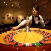 A woman spins a roulette wheel at a mock casino operated by Japan Casino School in Tokyo. | BLOOMBERG