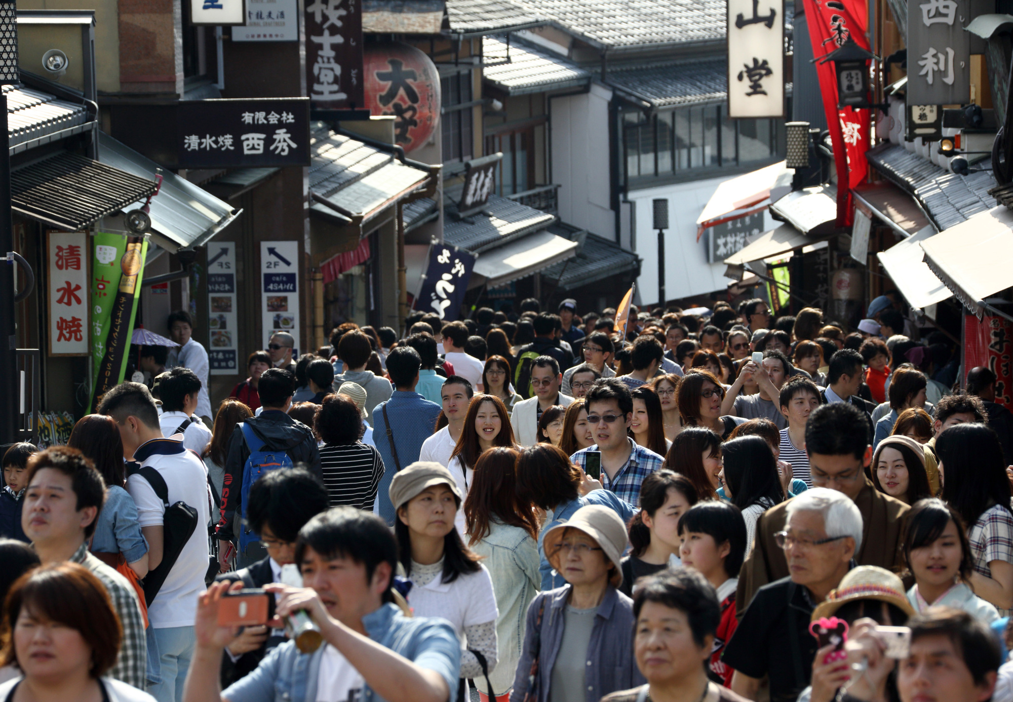 Standing room only: Tourists walk along Matsubara-dori street approaching the Kiyomizu Temple in Kyoto. | BLOOMBERG