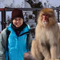 Primatologist Rafaela Takeshita and a Japanese macaque pose for the camera. | COURTESY OF RAFAELA TAKESHITA