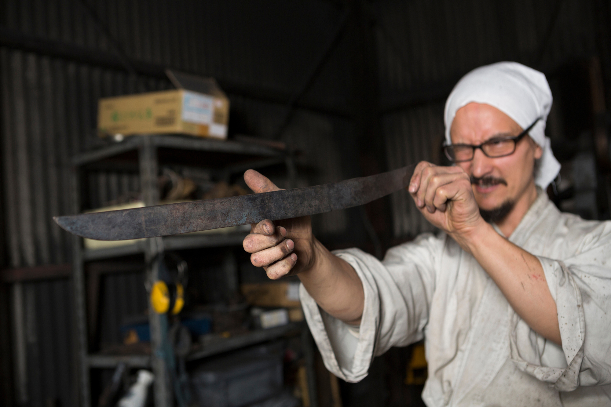 Yasha Yukawa checks his handiwork at his forge in the valleys around Hofu in Yamaguchi Prefecture. | CHRISTINA SJOGREN