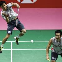 Japan\'s Yuta Watanabe hits a return as doubles partner Keigo Sonoda looks on during their Thomas Cup final match against China in Bangkok on Sunday. | AFP-JIJI