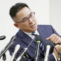 Yasutoshi Okuno holds a news conference in Osaka on Tuesday, speaking about a dirty hit by Nihon University defensive end Taisuke Miyagawa in a May 6 game that injured his son, a Kwansei Gakuin University quarterback. | KYODO