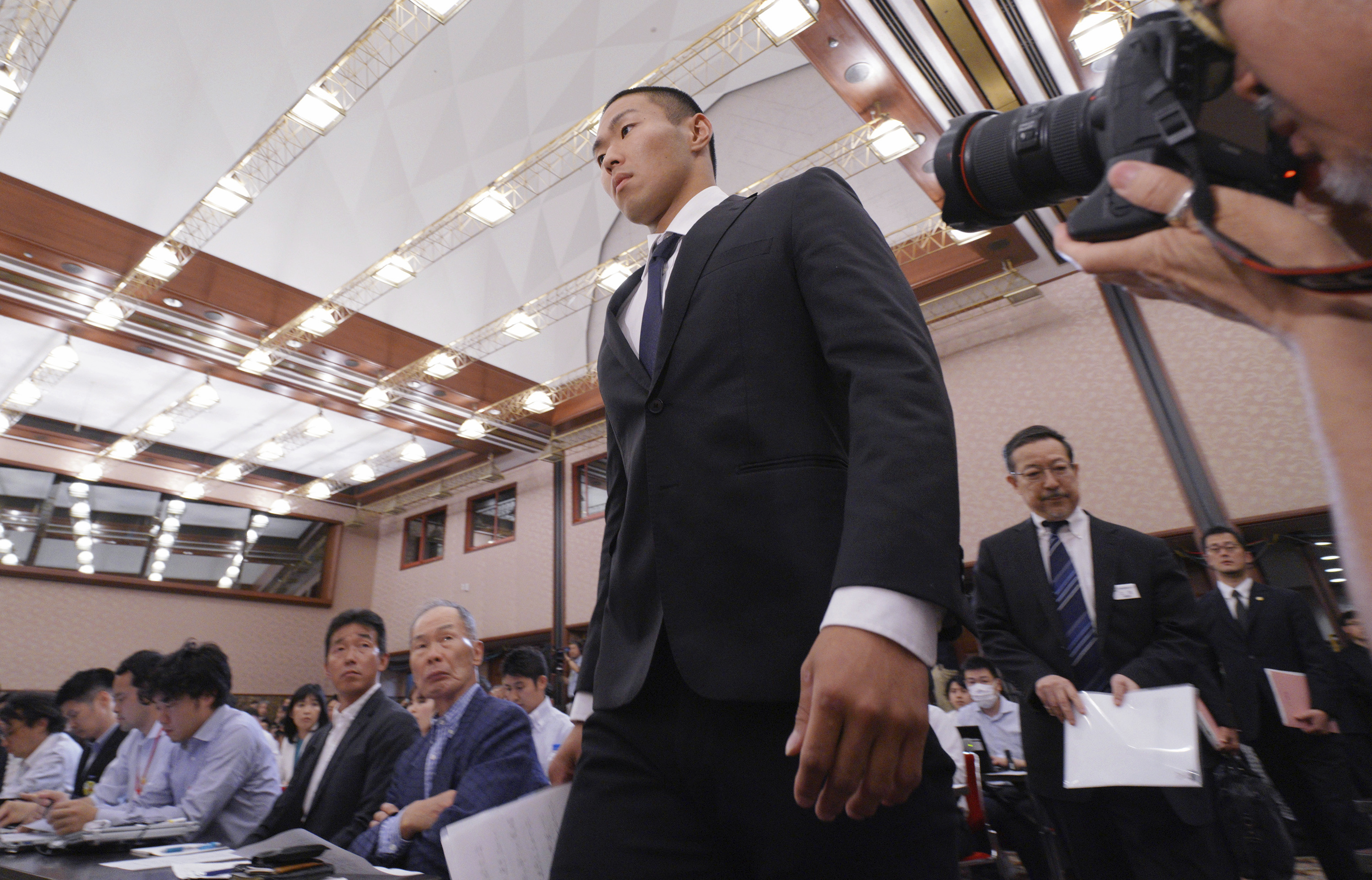 Taisuke Miyagawa, a Nihon University American football player, arrives for a news conference on Tuesday in Tokyo. | AP
