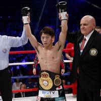 Naoya Inoue celebrates his victory over WBA bantamweight champion Jamie McDonnell on Friday night at Ota City General Gymnasium. | AP