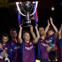 Andres Iniesta lifts the Spanish League trophy during a ceremony held in his honor in Barcelona on May 20. | AFP-JIJI