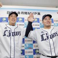 Seibu Lions pitcher Shinsaburo Tawata and infielder Hotaka Yamakawa pose for photos during a news conference after being named the Pacific League\'s monthly MVPs for games played during the March-April period. | KYODO
