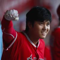Shohei Ohtani gestures from the dugout during the first inning of the Angels\' game against the Astros on Tuesday in Anaheim, California. | AP