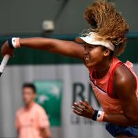Naomi Osaka hits a shot during her first-round win over Sofia Kenin of the United States at the French Open on Monday. | AFP-JIJI