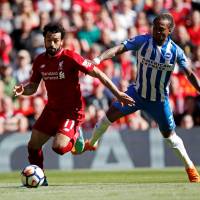 Liverpool forward Mohamed Salah (left) takes on Brighton\'s Gaetan Bong during their Premier League match at Anfield on Sunday. | ACTION IMAGES VIA REUTERS