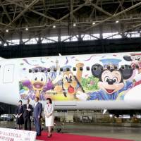 A Disney-themed Japan Airlines jet is seen on Friday at Haneda airport. | KYODO
