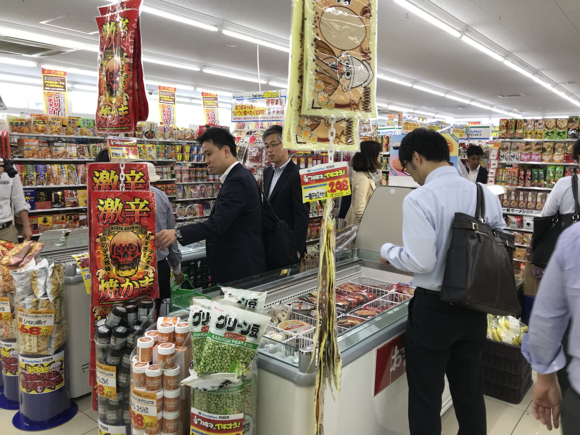 Customers check out a store jointly operated by FamilyMart and Don Quijote on Friday in the city of Tachikawa in western Tokyo. | KAZUAKI NAGATA