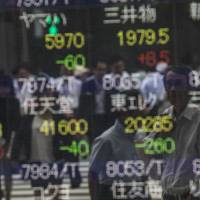 An electronic stock board outside a securities firm in Tokyo shows stock prices. One Oslo-based hedge fund is betting on unloved stocks in Japan, in a strategy that has delivered returns. | BLOOMBERG