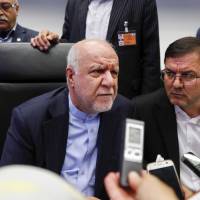Iranian Oil Minister Bijan Namdar Zanganeh (left) speaks to reporters ahead of the OPEC meeting in Vienna on Friday. | BLOOMBERG