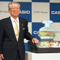Kazuo Kashio, then-president of Casio Computer Co., attends a news conference in November 2012 in Tokyo to unveil a small projector with a built-in screen in the shape of a person or character. | KYODO