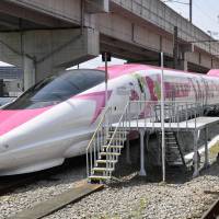A bullet train with a Hello Kitty motif is shown to the media Monday at a train yard in the city of Fukuoka. | KYODO