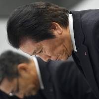 Mitsubishi Materials Corp. President Akira Takeuchi bows during a news conference in Tokyo in March when the firm revealed details about a series of quality data falsifications. | KYODO