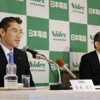 New Nidec Corp. President Hiroyuki Yoshimoto (left) speaks during a news conference next to Chairman Shigenobu Nagamori in Kyoto on Wednesday. | KYODO