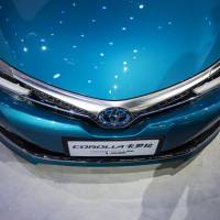 The Toyota Motor Corp. vehicle is displayed in Beijing. Toyota Motor Corp. and KDDI Corp. have persuaded several other Japanese carmakers to test and deploy connected-car technology. | BLOOMBERG