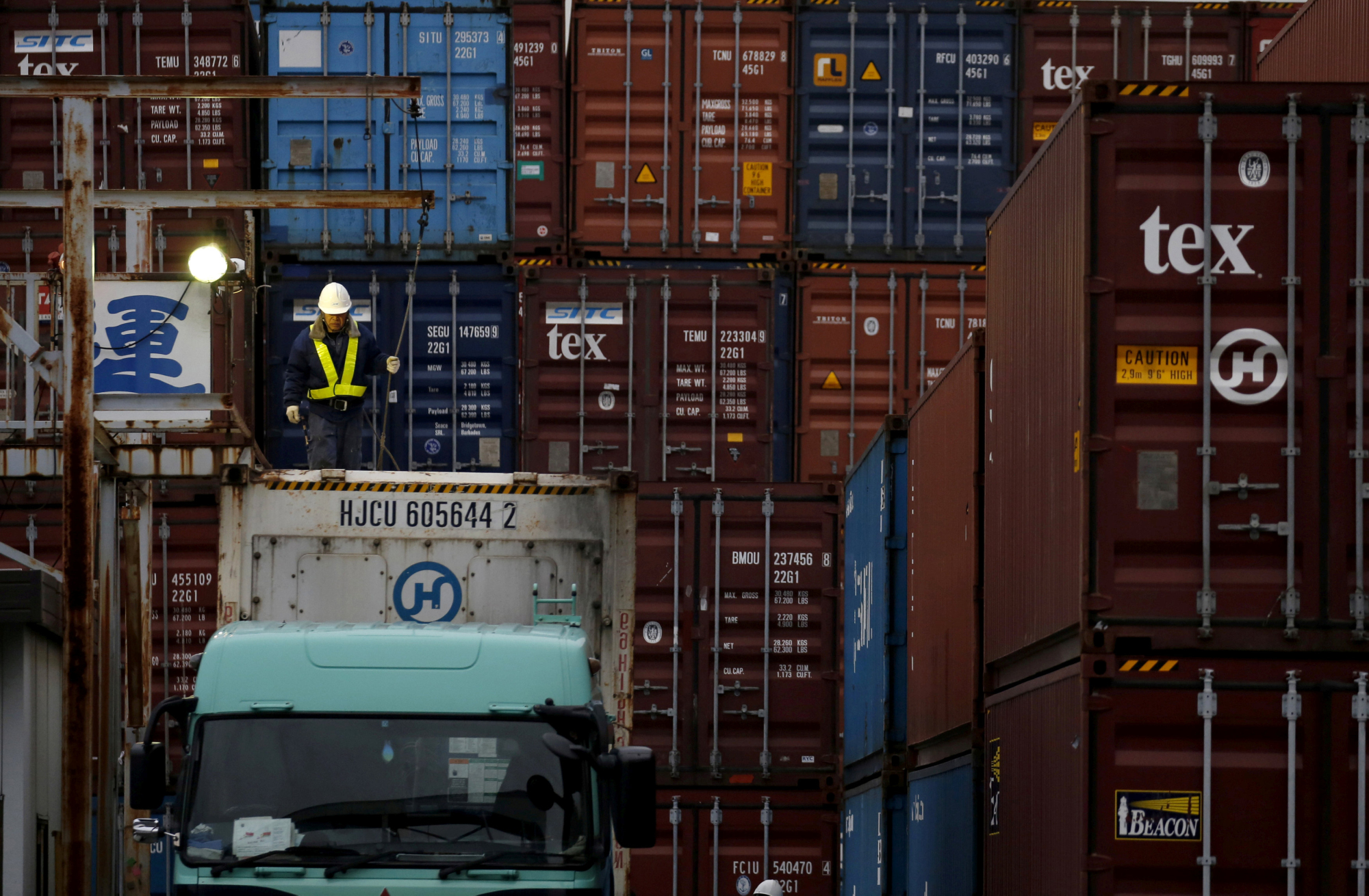 A laborer works in a container area at a port in Tokyo in  2016. Japan's exports rose in May this year at the fastest rate in four months, thanks to increased shipments of cars, car parts and semiconductor equipment. | REUTERS