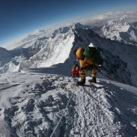 Mountaineers make their way to the summit of Mount Everest as they ascend on the south face from Nepal on May 17. | AFP-JIJI