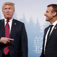 U.S. President Donald Trump meets with French President Emmanuel Macron during the Group of Seven summit on Friday in La Malbaie, Quebec. | AP