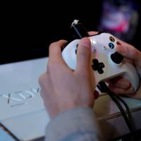 A gamer plays video games with a Xbox console during the 2017 Paris Games Week exhibition at the Porte de Versailles exhibition center in Paris in 2017. Video gaming can be addictive in the same way as cocaine or gambling, the World Health Organization said Monday in a much anticipated update of the International Classification of Diseases (ICD-11). | AFP-JIJI