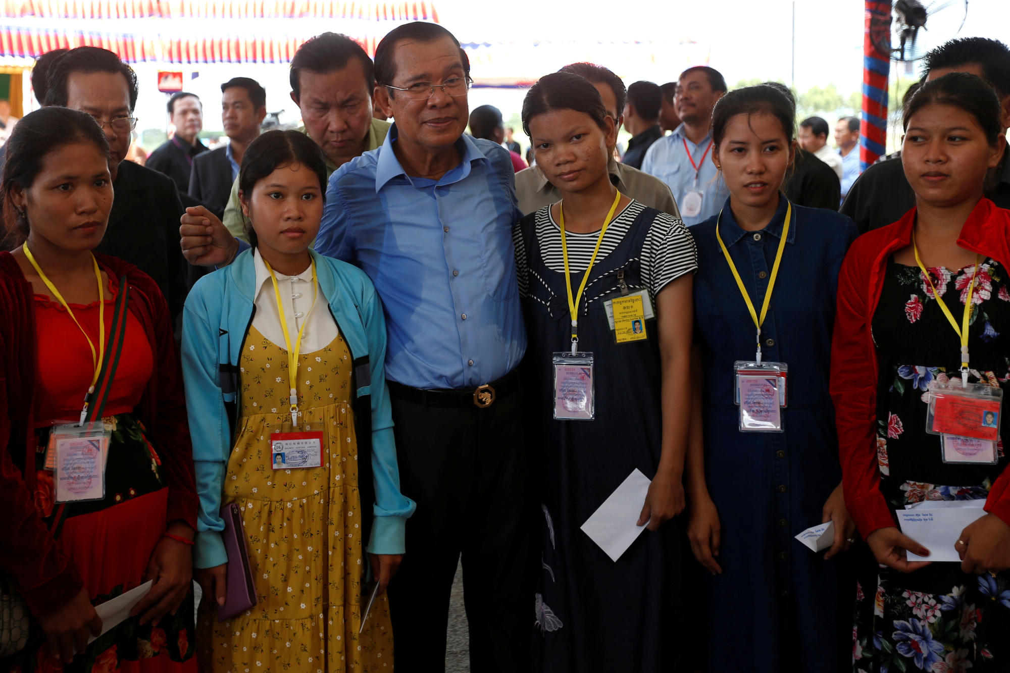 Cambodian Prime Minister Hun Sen poses with garment workers during a rally in Kandal province on May 30. | REUTERS