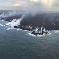 An aerial view is seen Saturday of the Kapoho ocean entry, showing the extent of the lava delta, now about 200 acres in size, that has formed over the past six days as it enters the Pacific Ocean as Kilauea Volcano continues its eruption cycle near Pahoa on the island of Hawaii. Across the front of the delta, plumes of laze, created by molten lava interacting with seawater, appeared diminished early morning, but was probably due to a change in atmospheric conditions rather than a change in the amount of fissure 8 lava reaching the ocean. | U.S. GEOLOGICAL SURVEY / VIA AP