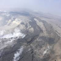 This Saturday aerial photo provided by the U.S. Geological Survey shows cracking and slumping of the Halema\'uma\'u crater walls. | U.S. GEOLOGICAL SURVEY / VIA AP
