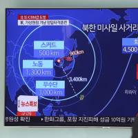 A South Korean at Seoul Station watches a TV news report about a North Korean missile launch in November. | AP
