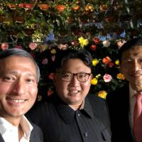 North Korean leader Kim Jong Un, Singaporean Foreign Minister Vivian Balakrishnan (left) and Education Minister Ong Ye Kung pose for a selfie posted to Balakrishnan\'s official Twitter account in the city-state late Monday. | REUTERS