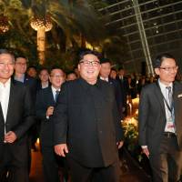 North Korean leader Kim Jong Un, accompanied by Singaporean Foreign Minister Vivian Balakrishnan (left), tours the city-state late Monday. | REUTERS