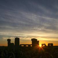 The sun can be seen rising through Stonehenge in Wiltshire, England, on June 21, 2018. Celebrations on the summer solstice, which date back thousands of years, mark the longest day of the year when the sun is at its maximum elevation. | AFP-JIJI