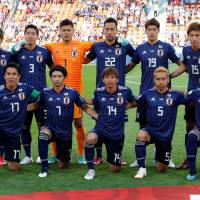 Japan players pose before the Japan vs Senegal match on June 24. | REUTERS