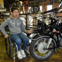 Ko Sawada, a former motorcycle racer who now uses a wheelchair, shows off classic bikes at his shop Motocyclette Sawada, in Shinshiro, Aichi Prefecture. | CHUNICHI SHIMBUN