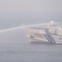 A Japan Coast Guard ship fires a water cannon at a North Korean fishing boat within Japan\'s EEZ near the Yamato Bank in the Sea of Japan. | JAPAN COAST GUARD