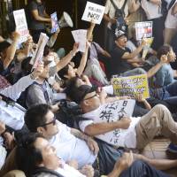 Protesters sit at a public hall in Kawasaki to block people from attending an alleged hate speech event targeting ethnic Korean residents on June 3, two years after Japan\'s anti-hate speech law took effect. | KYODO