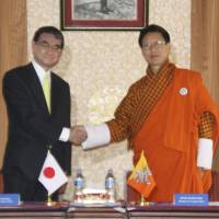 Foreign Minister Taro Kono meets with his Bhutanese counterpart, Damcho Dorji, in Thimphu on Saturday. | KYODO