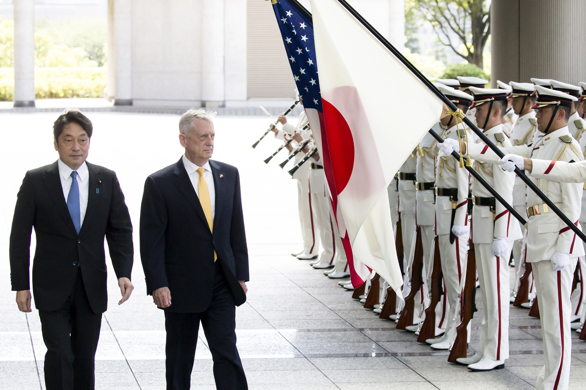 Defense Minister Itsunori Onodera and U.S. Defense Secretary Jim Mattis review an honor guard before their meeting at the Defense Ministry in Tokyo on Friday. | AP