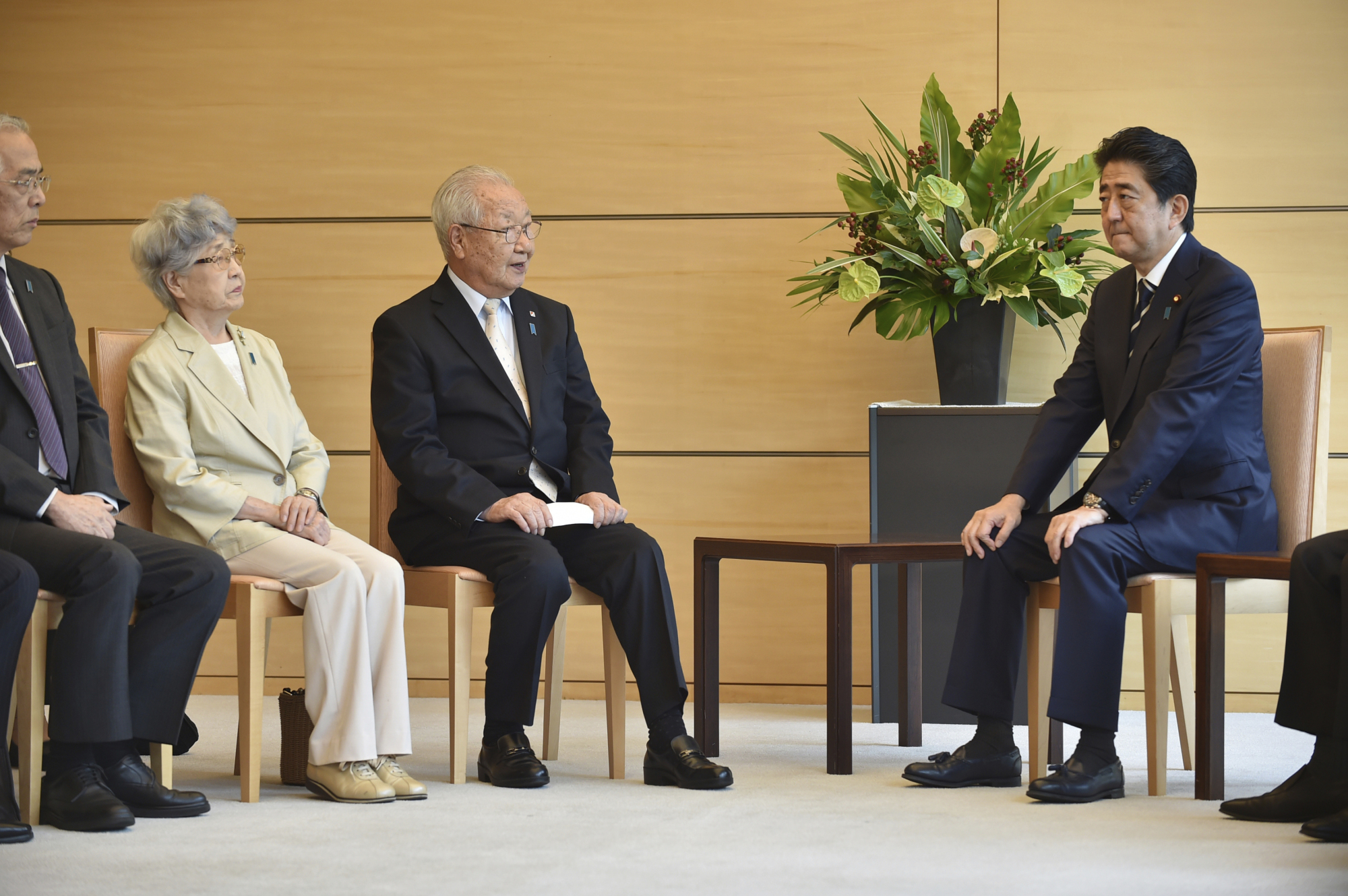 Prime Minister Shinzo Abe listens to Shigeo Iizuka (third from left), leader of a group of families of Japanese abducted by North Korea, and Sakie Yokota (second from left), mother of abductee Megumi Yokota, during a meeting at his official residence in Tokyo on Thursday. | AP