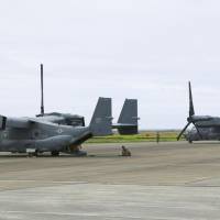 Two U.S. Air Force Ospreys sit at the airport on Amami-Oshima Island in Kagoshima Prefecture after making emergency landings Monday. | KYODO
