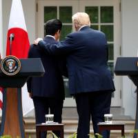 U.S. President Donald Trump and Prime Minister Shinzo Abe leave after holding a joint news conference in the Rose Garden of the White House on Thursday. | REUTERS