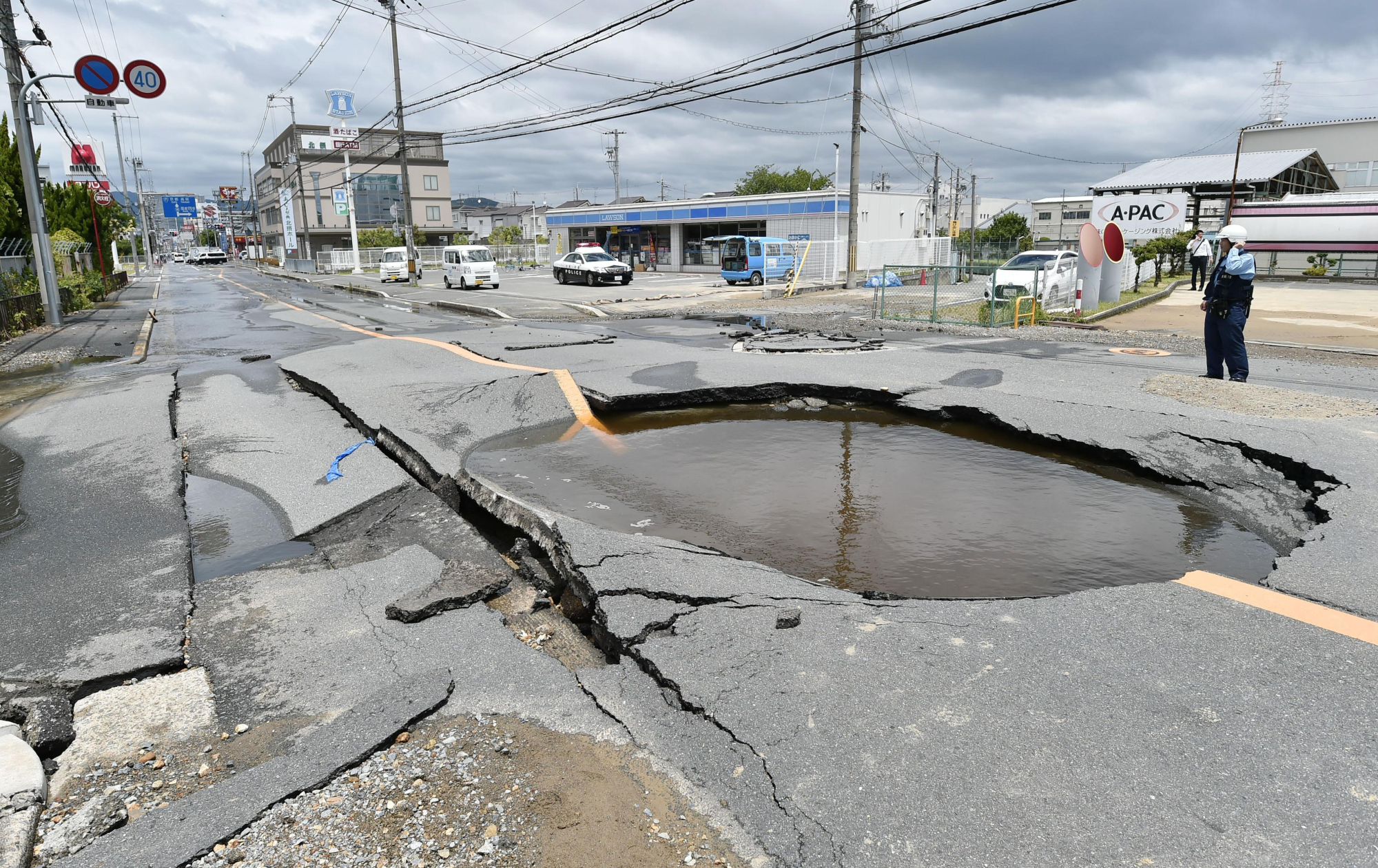 A burst water pipe caused a sinkhole in Takatsuki, Osaka Prefecture, after a powerful earthquake hit the prefecture and its vicinity on June 18. | KYODO