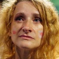 Barbara Henmi, a Polish resident in Japan, watches Japan and Poland\'s match in the World Cup, the final game in the tournament\'s group stage, at M-Spo Sports Bar in Shibuya Ward, Tokyo, on Thursday night. | MAGDALENA OSUMI