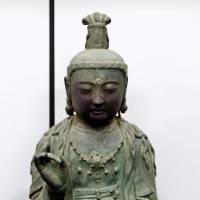 An ancient Buddhist statue stolen from a Japanese temple in 2012 is shown in January 2013 in Daejon, South Korea. | YONHAP / VIA KYODO