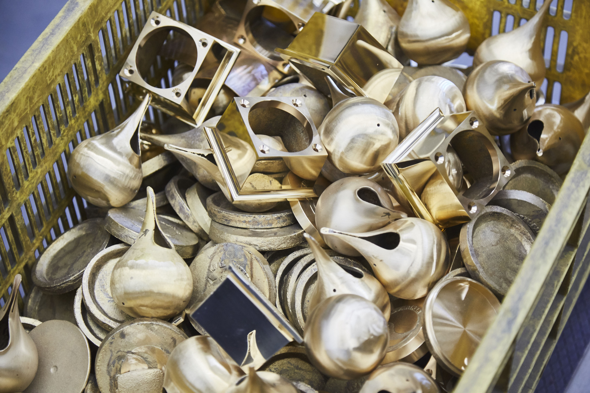 Metal castings sit in a basket at Nousaku's foundry. | YASUSHI NAKAMURA