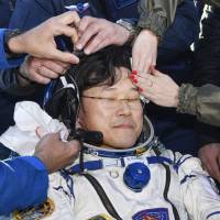 Long time gone: Astronaut Norishige Kanai is tended to upon his return to Earth. | KYODO