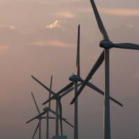 Wind turbines operate in Kamisu, Ibaraki Prefecture. Japan’s per capita carbon dioxide emissions have increased since the 2011 Fukushima nuclear disaster. | BLOOMBERG