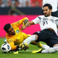 Ilkay Gundogan (right) and Germany will be trying to defend their World Cup crown in Russia this summer. | REUTERS